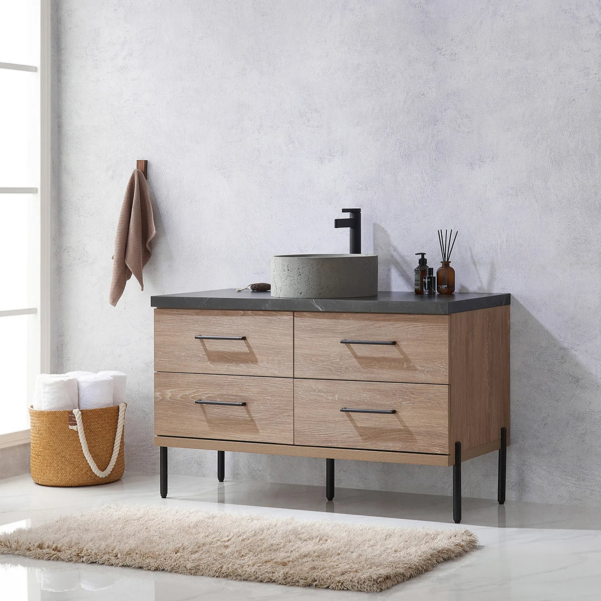 Side-on bathroom shot: drawer fronts and slim black legs in profile