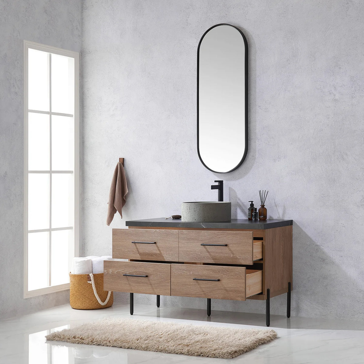 Looking up from the open drawers to the oval mirror hung on the wall