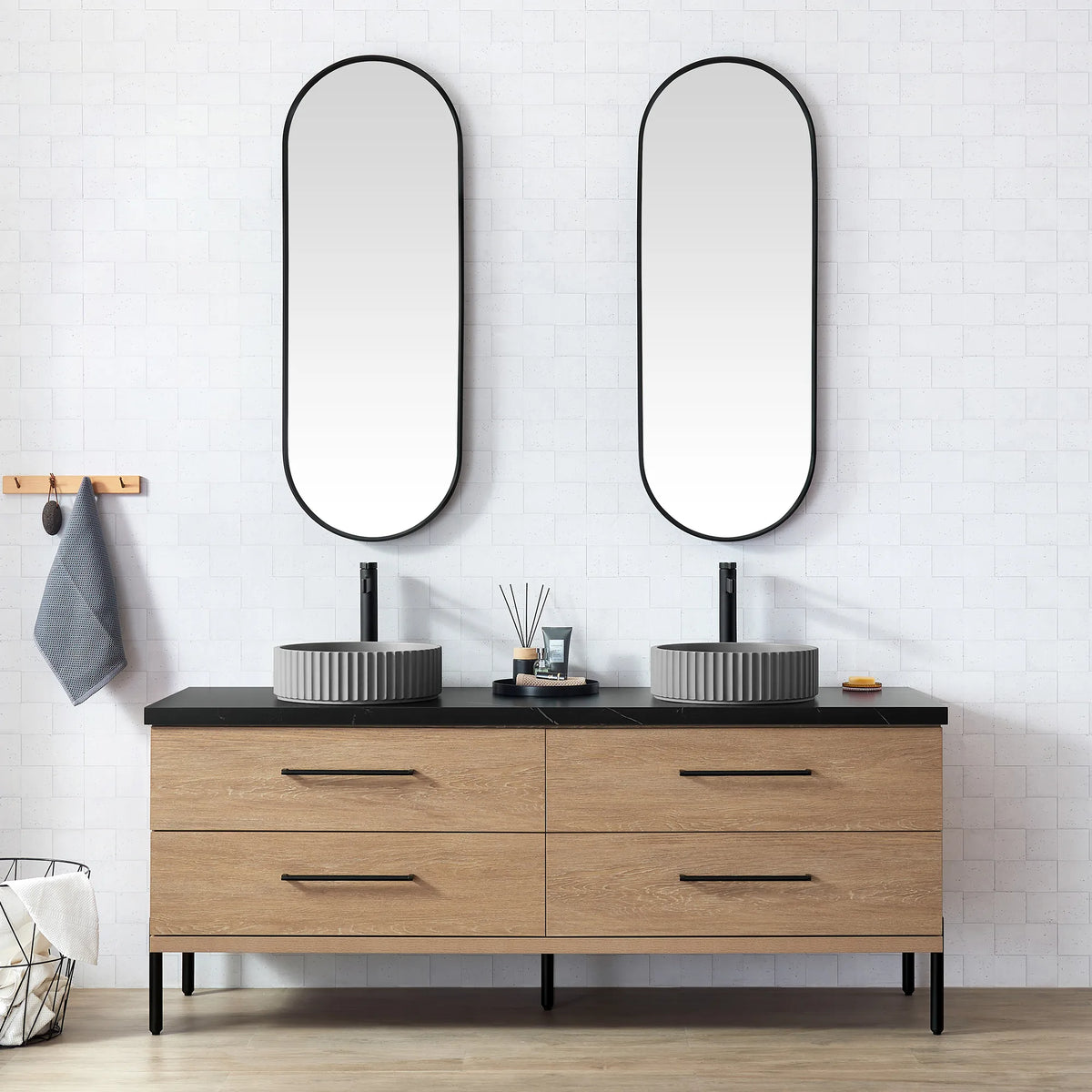 White brick-tile bathroom with oval mirrors and the oak vanity