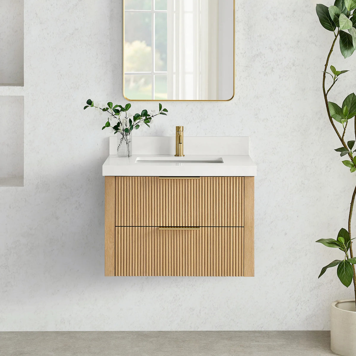 Wall-mounted Washed Ash Grey vanity with corrugated drawer fronts under a tall gold-framed mirror, plant beside it