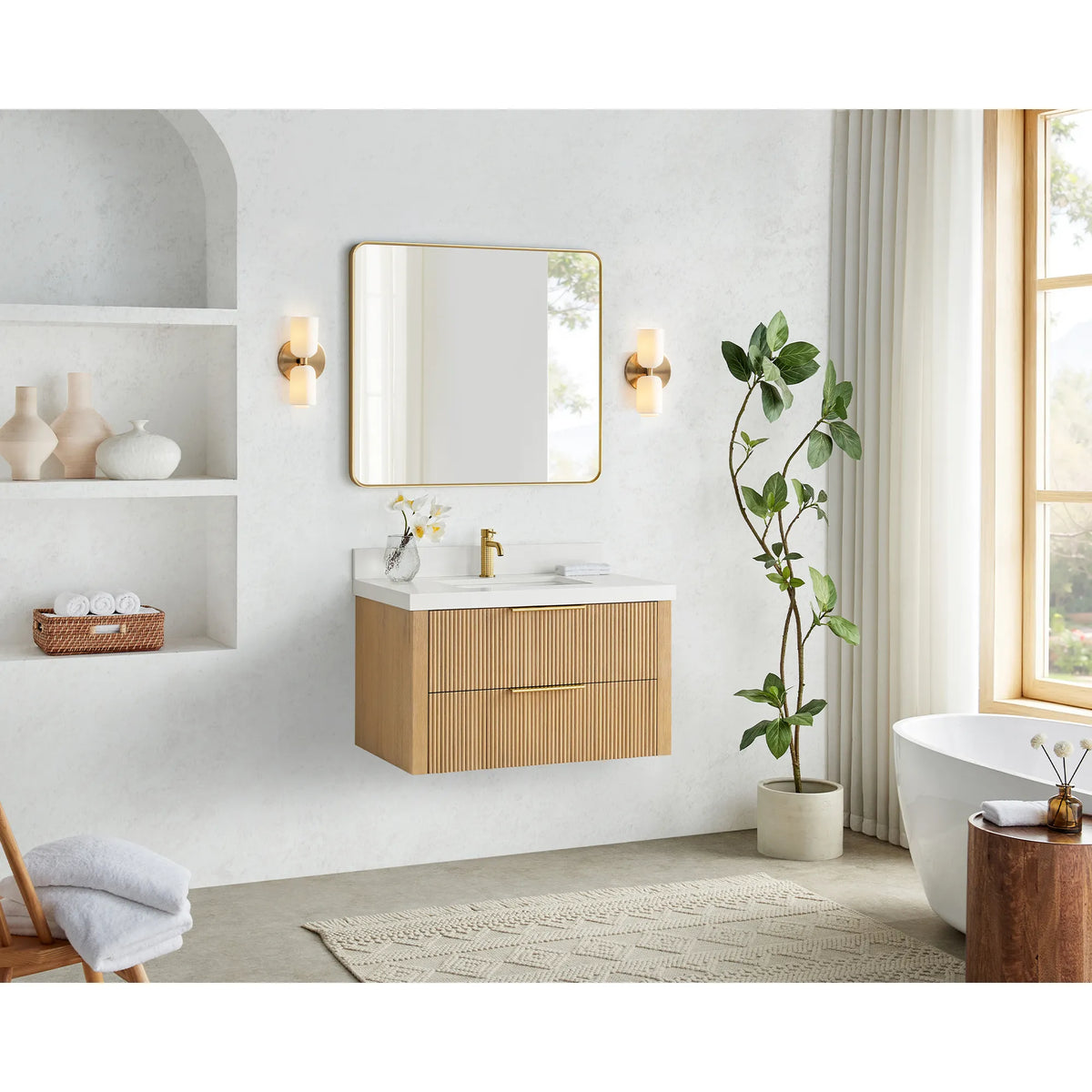 36 inch floating vanity in Washed Ash Grey, hung in a bright bathroom with a window, arched niche and soaking tub