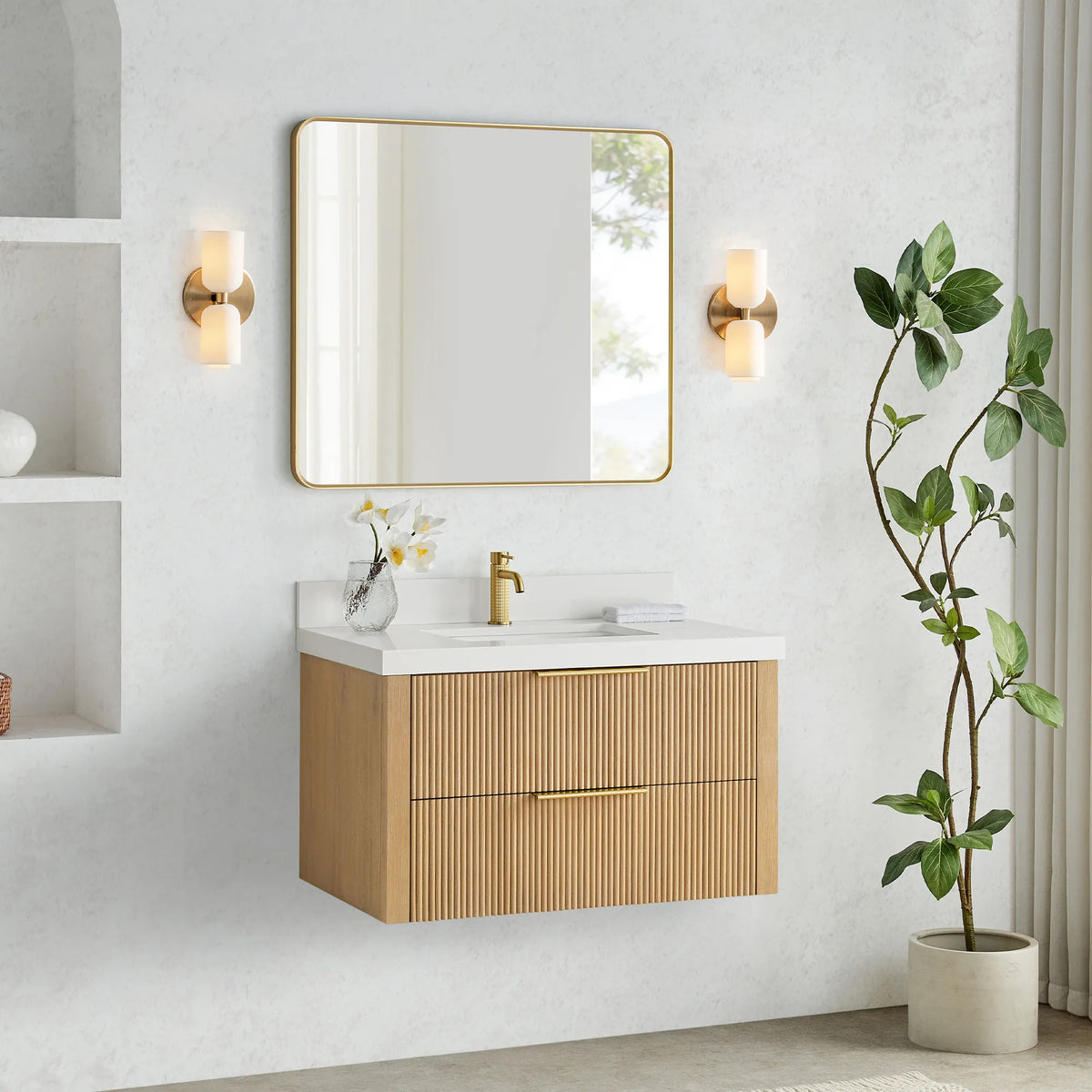 Washed Ash Grey floating vanity with sink and faucet, clear floor space below and a plant at right