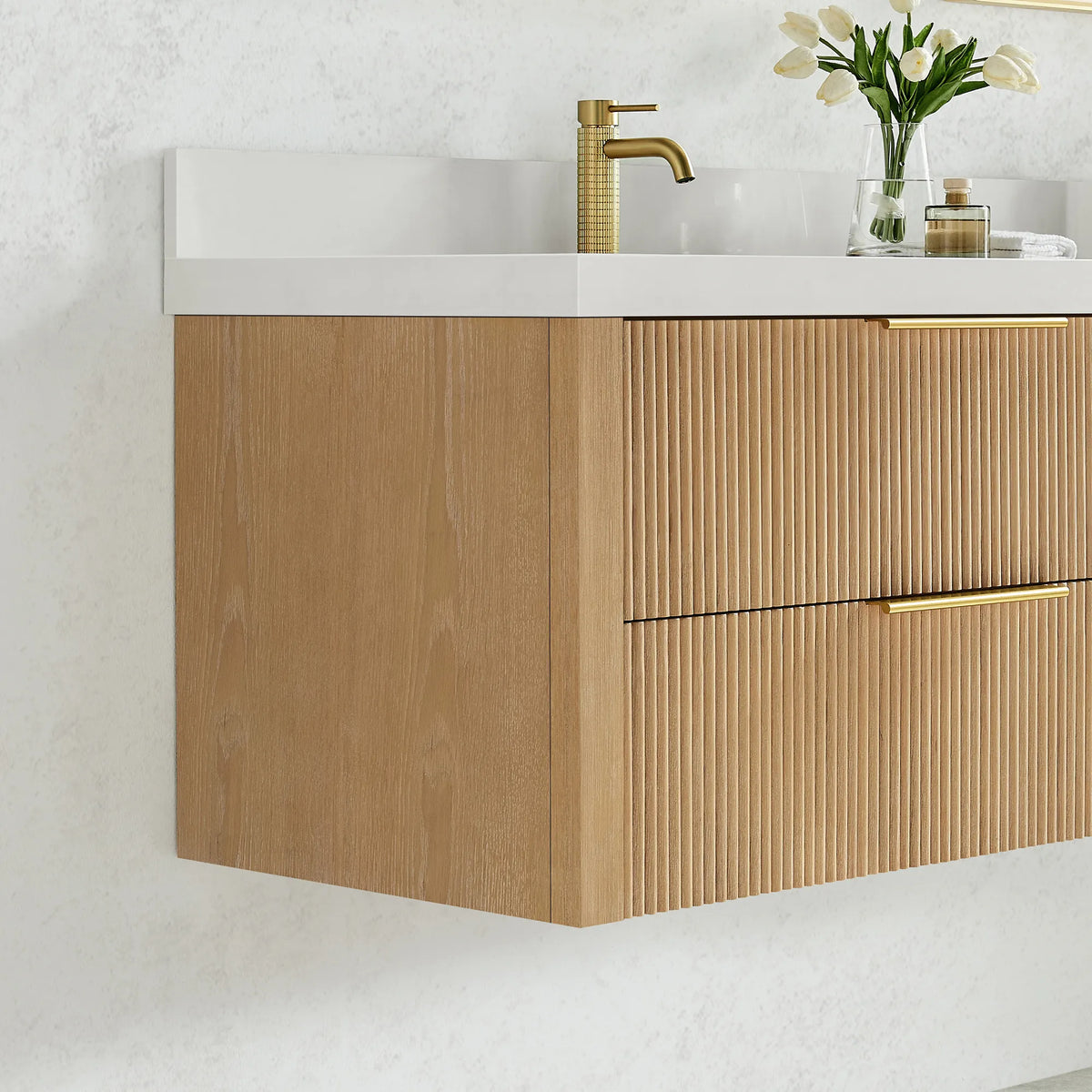 Cabinet side and corner of the floating 36 inch vanity with a faucet pictured, fluted drawer fronts in Washed Ash Grey