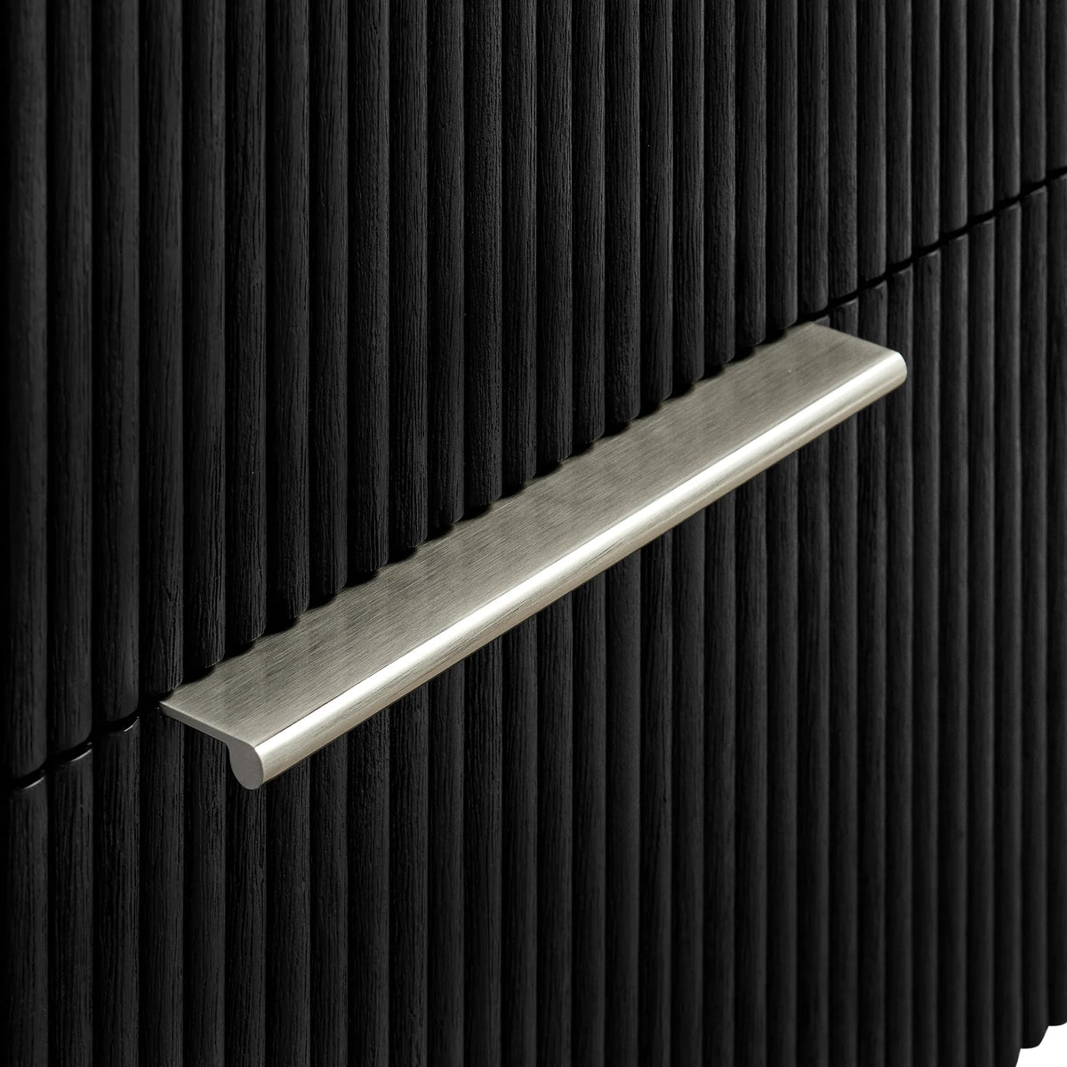 Handle detail: brushed nickel pull set into the ribbed Oak Weathered Black drawer face