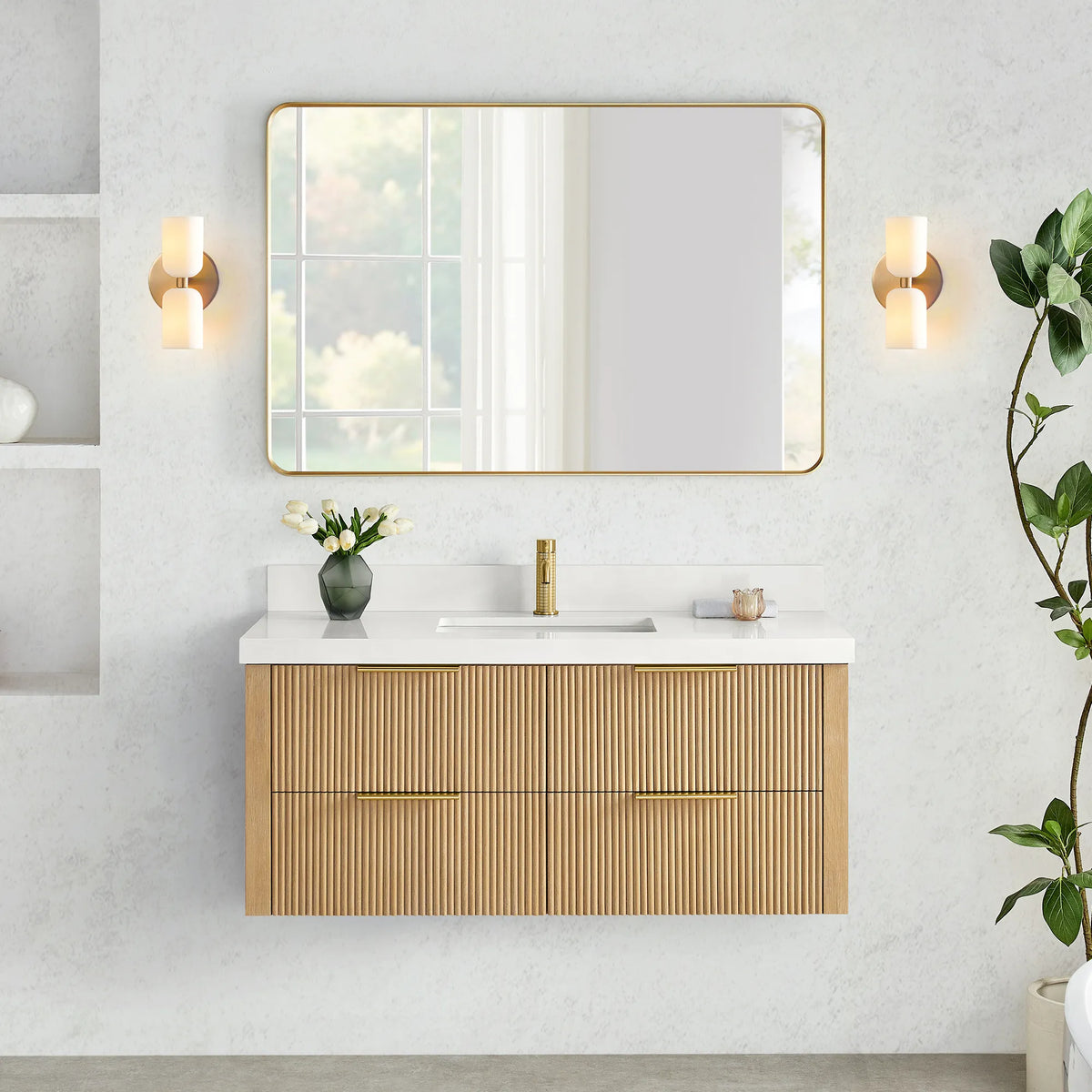 Wall-hung vanity in Washed Ash Grey with a wide rounded-rectangle mirror set between two wall sconces on a textured wall