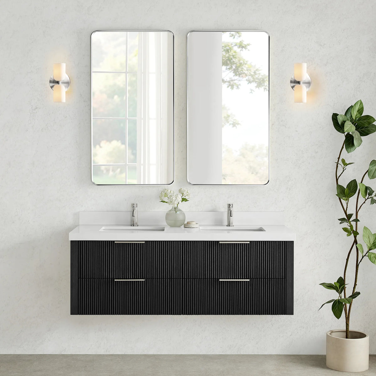 Wall-hung vanity in Oak Weathered Black with two tall mirrors set between two wall sconces on a textured wall