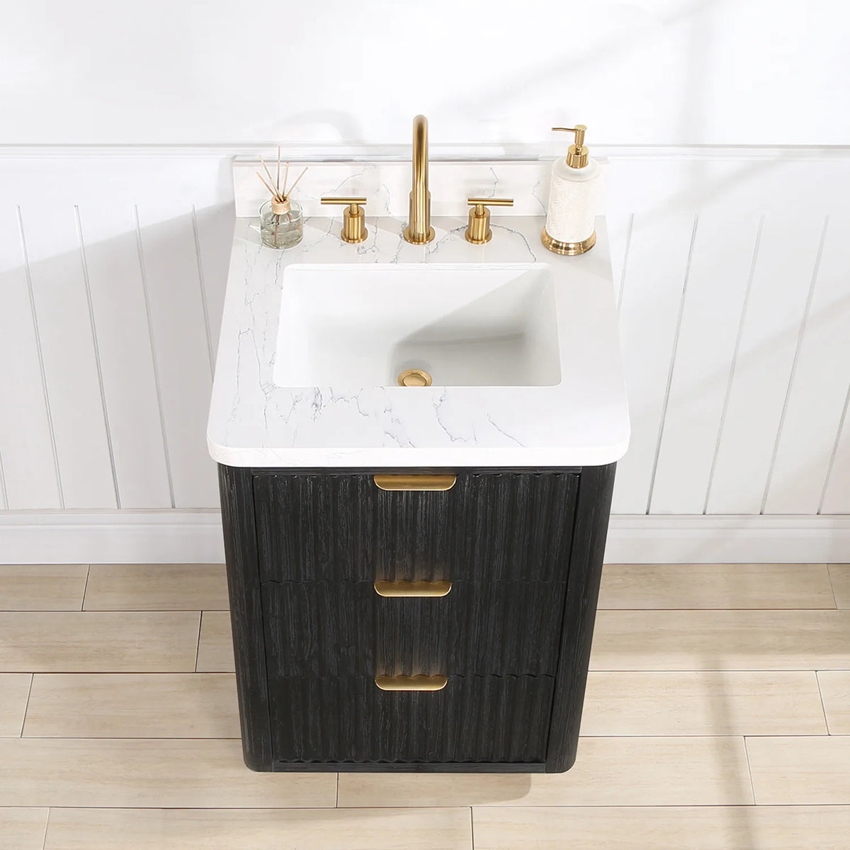 Top and basin close-up on the 24 inch vanity with a soap dispenser and diffuser set beside the faucet