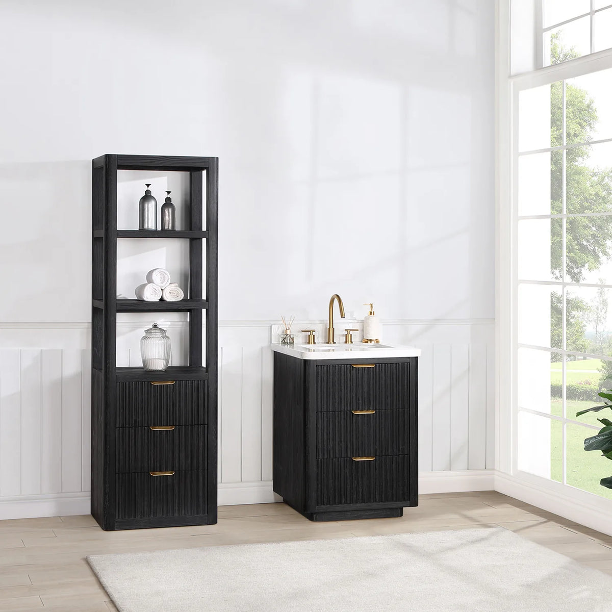 Room view of the freestanding 24 inch vanity beside tall windows with a light rug on the floor