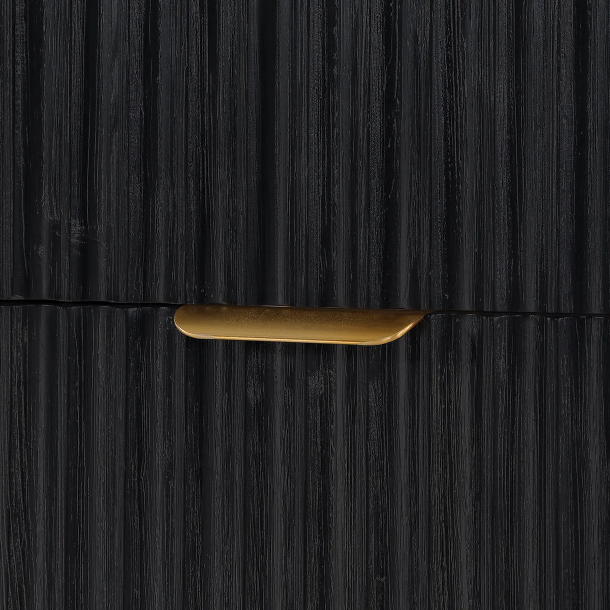 Close detail of a fluted drawer front with a slim curved pull on the Fir Wood Black cabinet