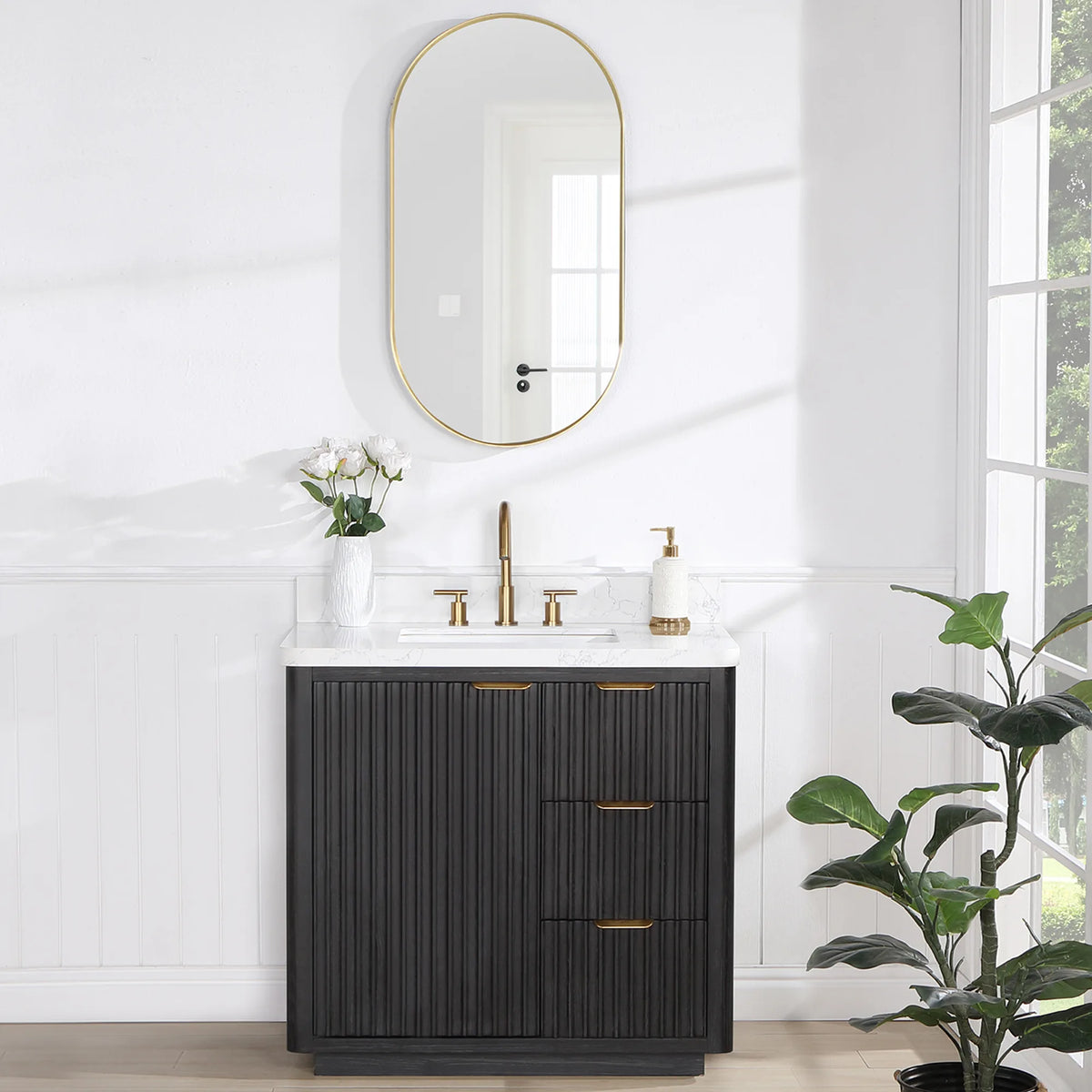 Room scene with the 36 inch vanity below an oval wall mirror, plant at the right and a window beyond