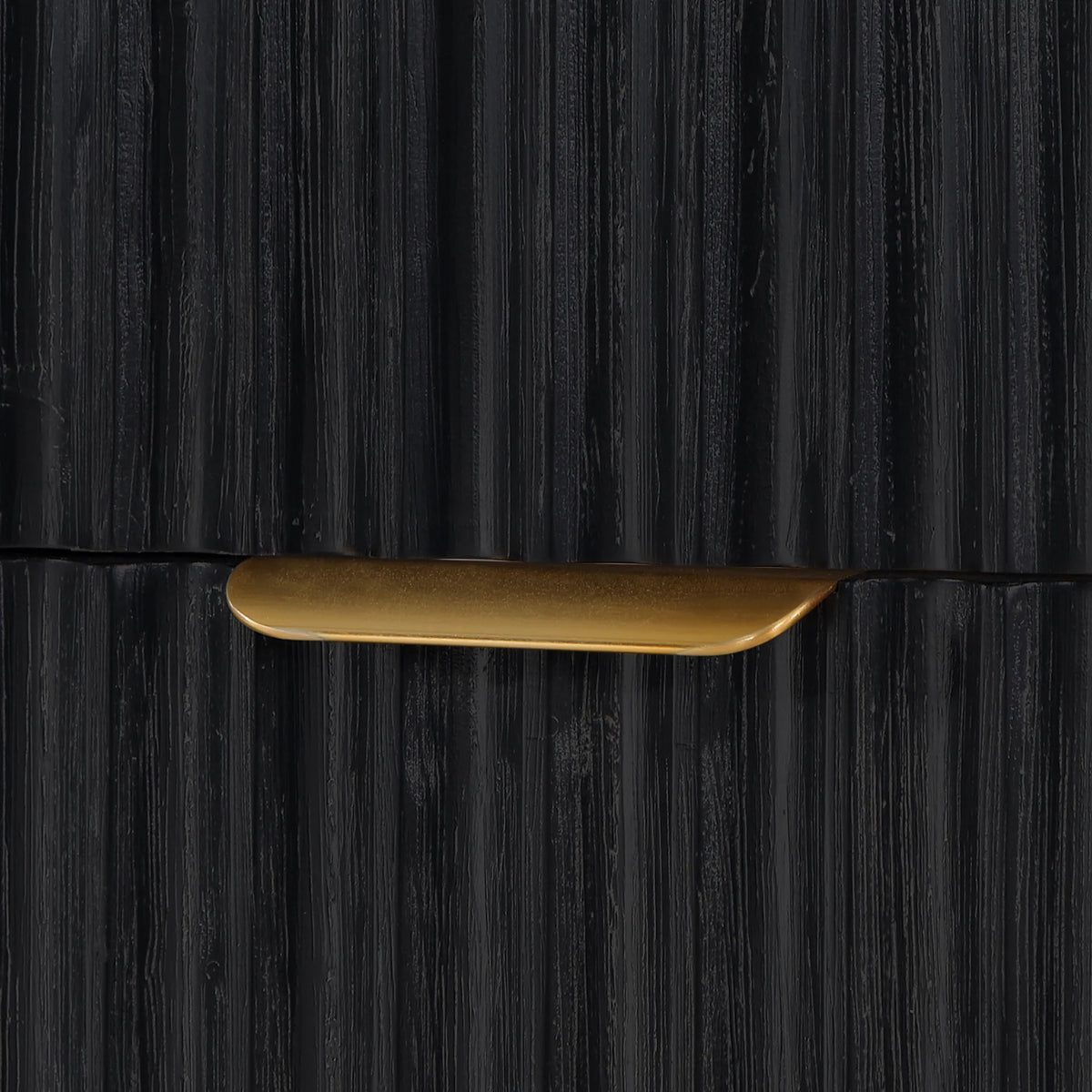 Close-up of a slim curved pull on a fluted drawer front in Fir Wood Black
