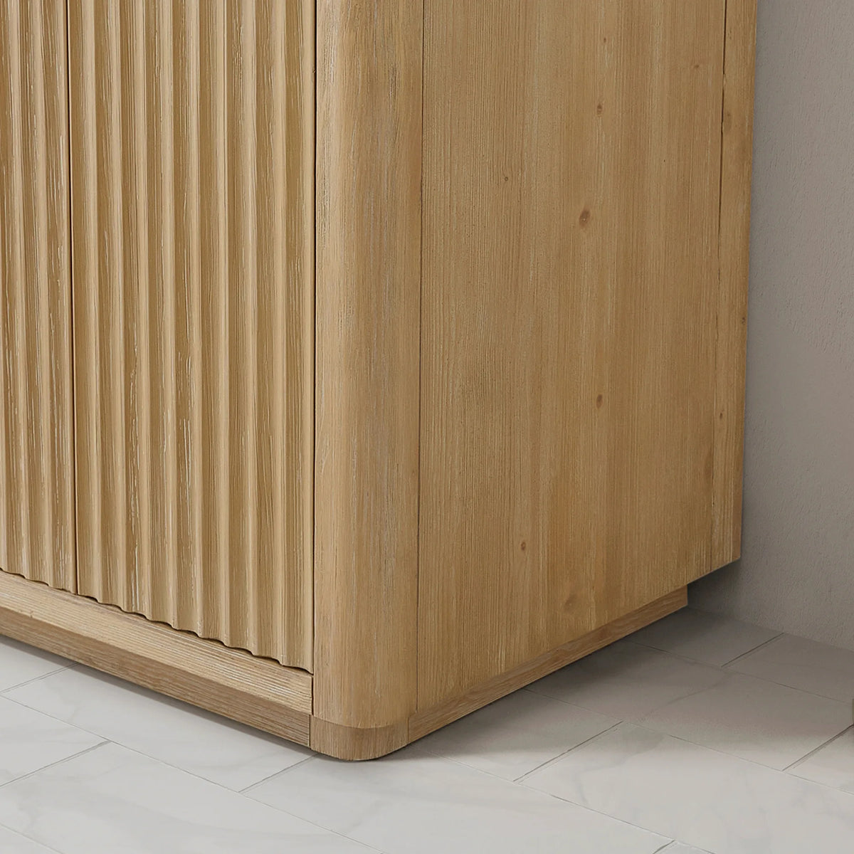 Cabinet corner and base close-up showing the vertical textured Washed Ash Grey wood