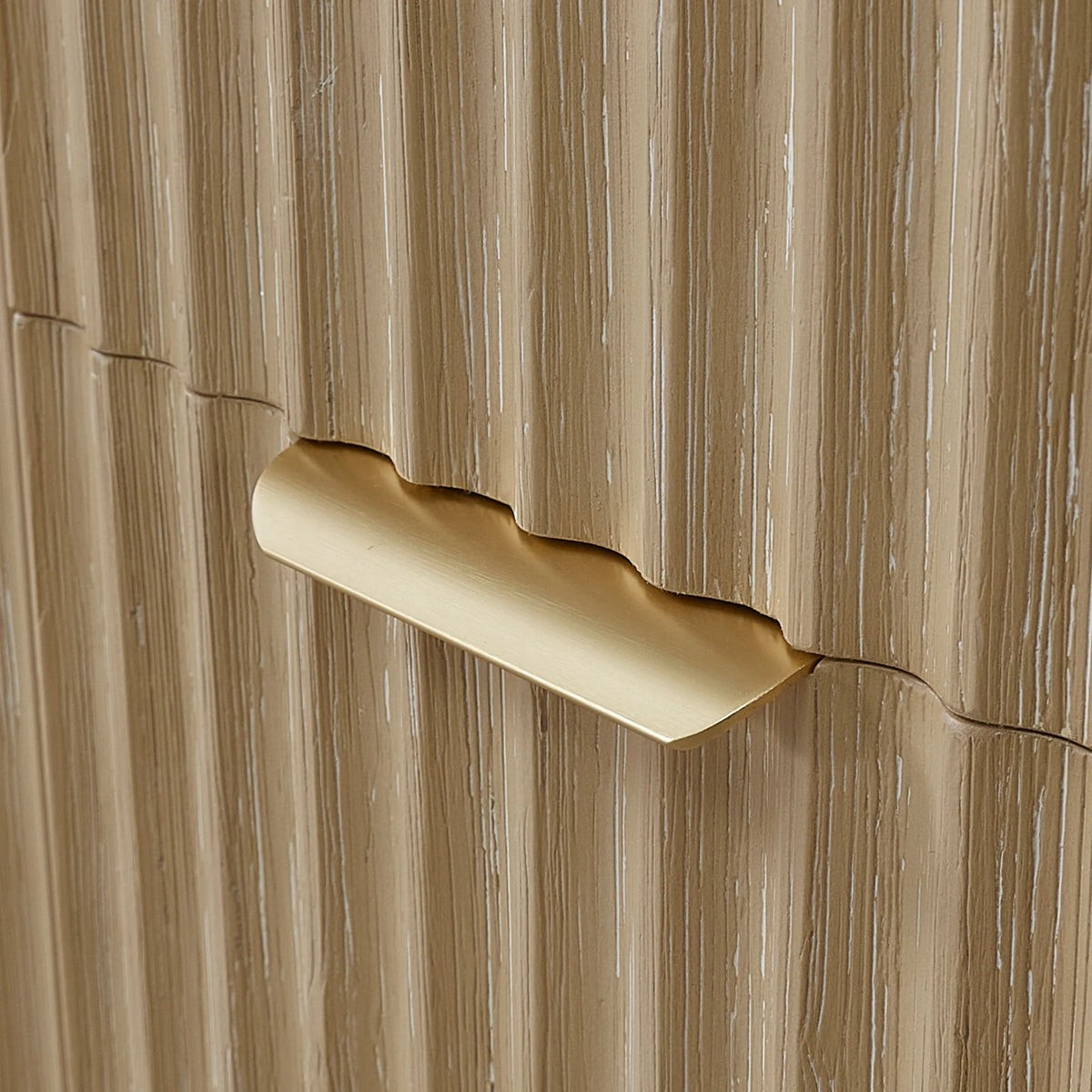 Close-up of the Brushed Gold handle set into the textured wood face