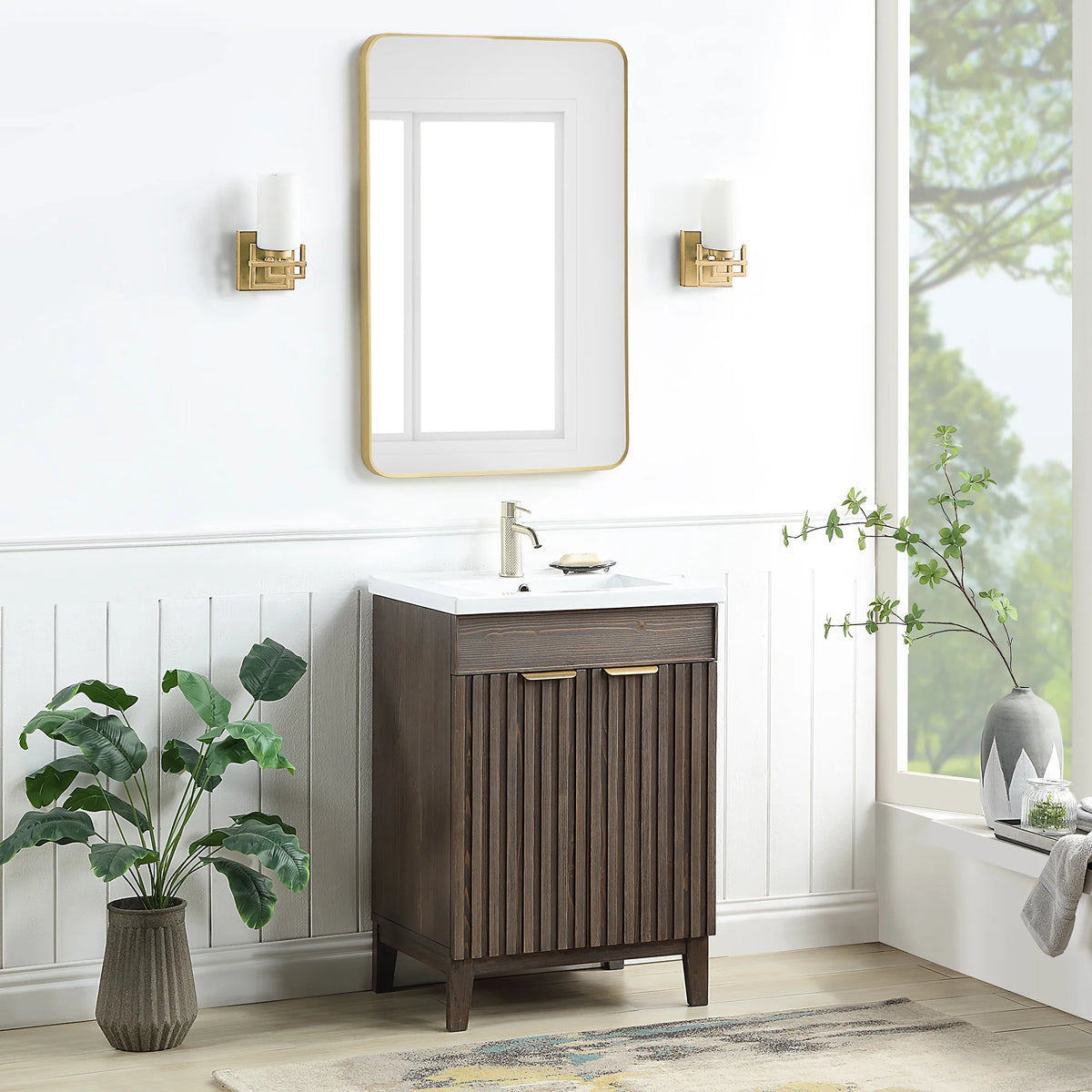 Wide shot of the Spruce Aged Brown cabinet and a rectangular wall mirror in a bath with white paneled walls